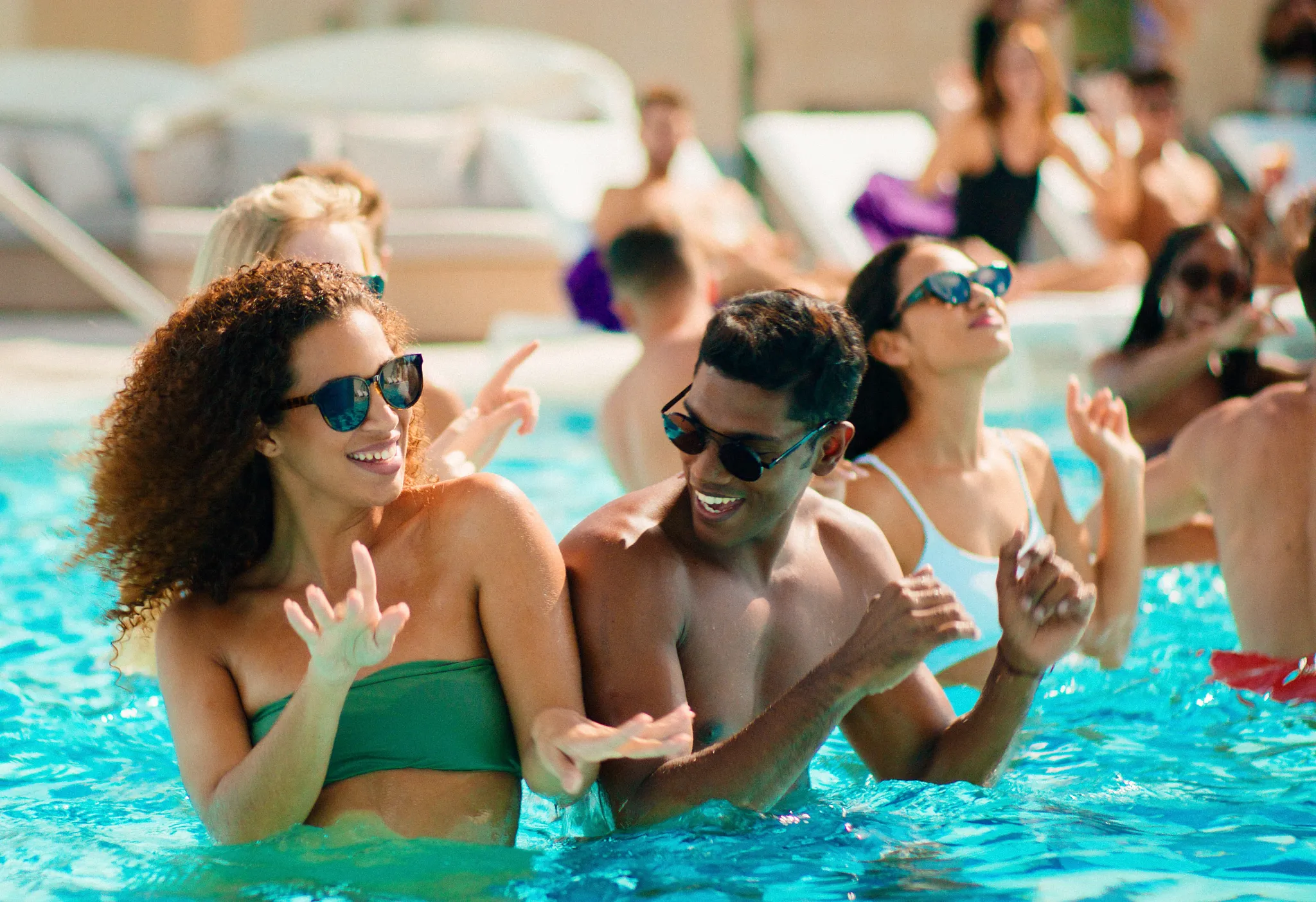 Friends enjoying a high-energy pool party at the Xcelerate pool at Breathless Cancun Soul Resort.