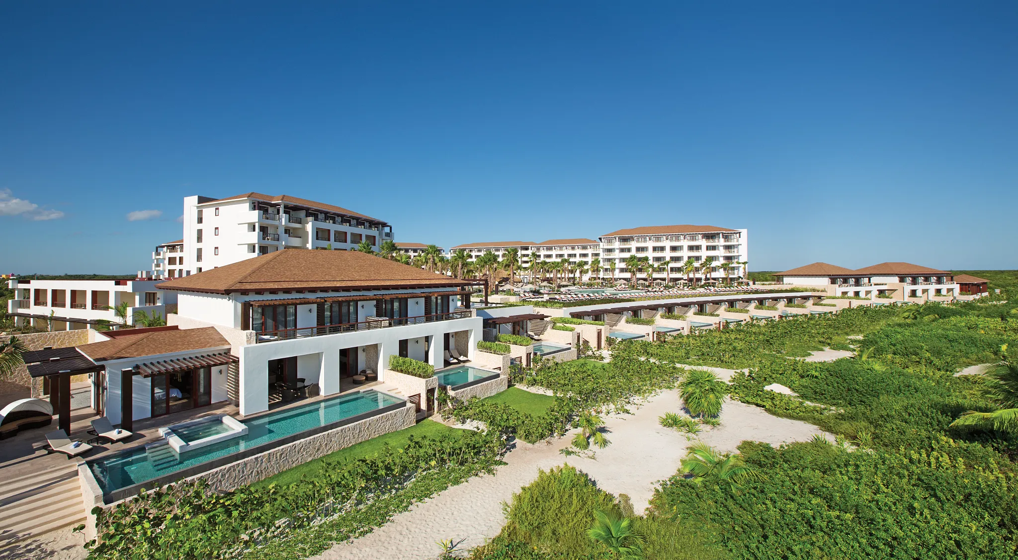 Aerial view of the main pool and beachfront at Secrets Playa Mujeres Golf & Spa Resort in Cancun.