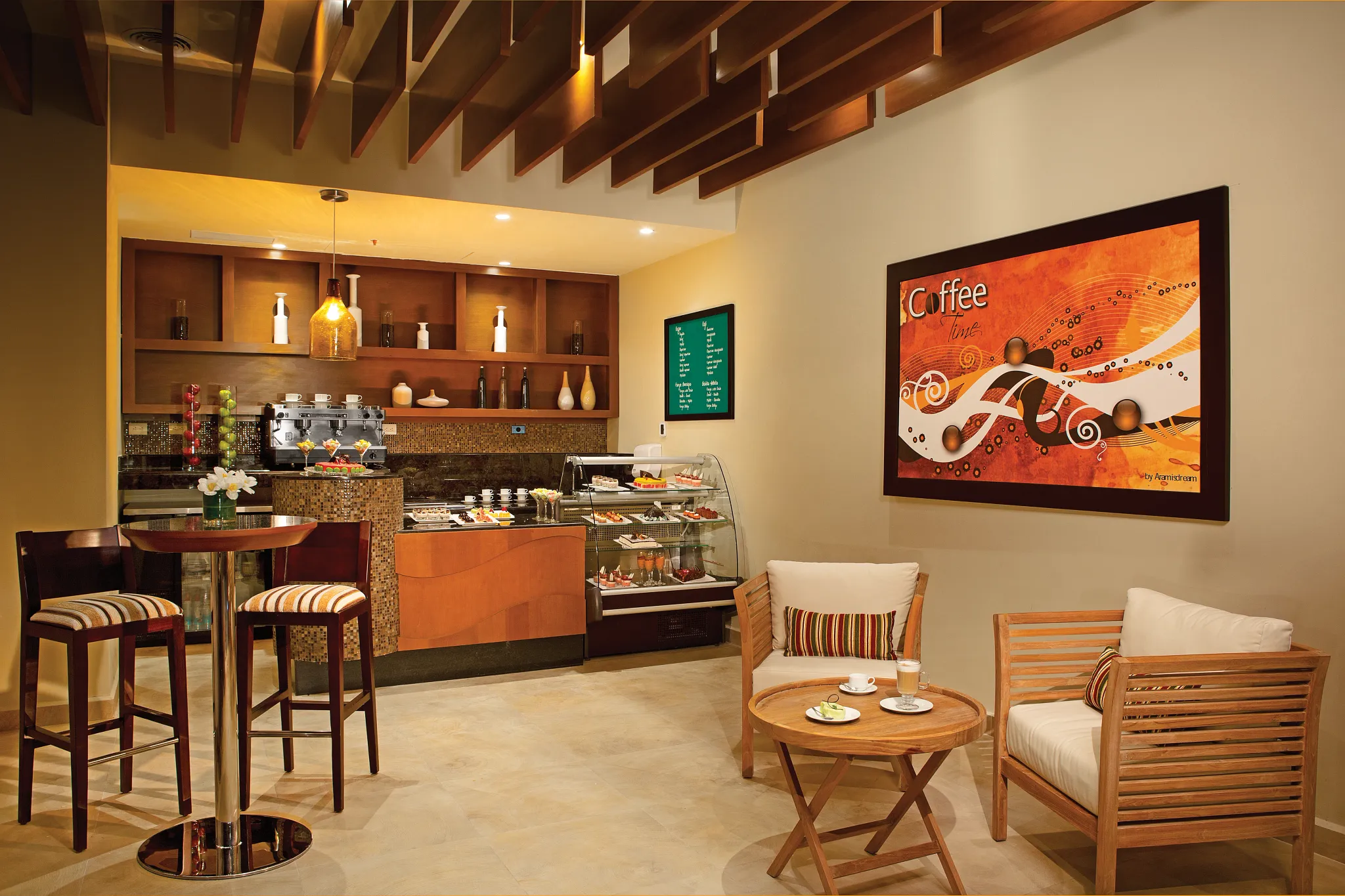 Coco Café coffee and snack bar at Secrets Playa Mujeres Golf & Spa Resort featuring espresso drinks, pastries, and a cozy café seating area.