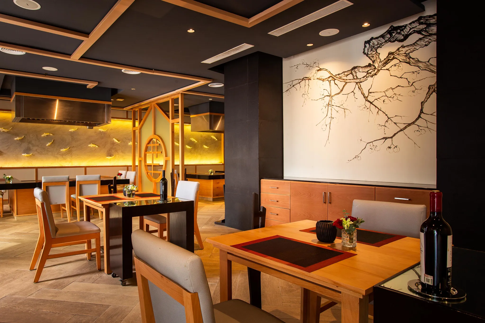 Himitsu Pan-Asian restaurant at Secrets Playa Mujeres Golf & Spa Resort featuring modern Asian-inspired décor, sushi bar, and Teppanyaki dining tables.