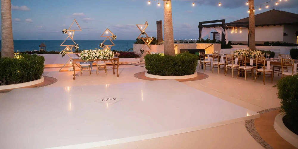 Infinity Terrace oceanview reception setup with dance floor at Secrets Playa Mujeres Golf & Spa Resort