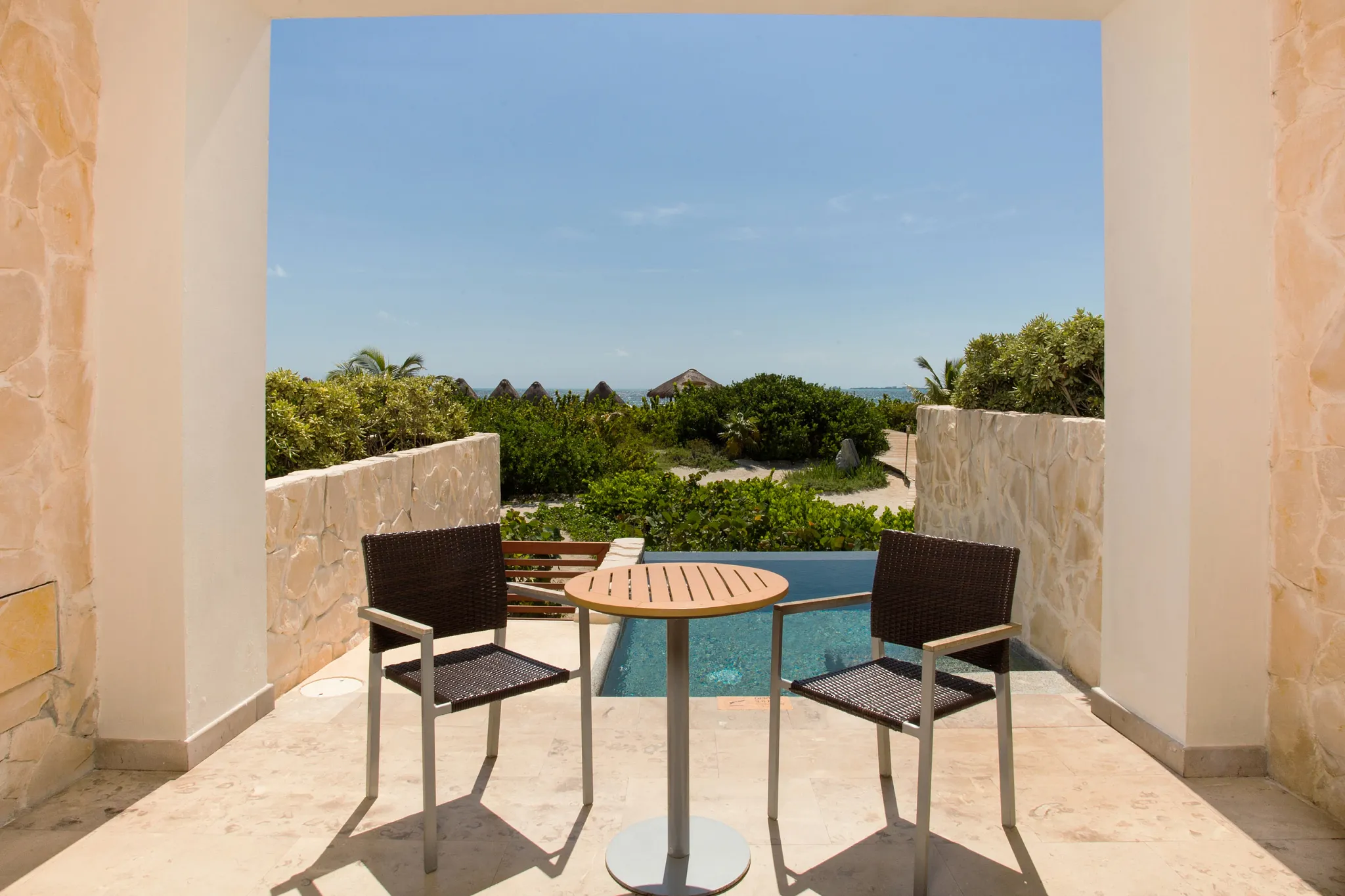 Preferred Club Junior Suite Ocean Front terrace with plunge pool and seating at Secrets Playa Mujeres Golf & Spa Resort.