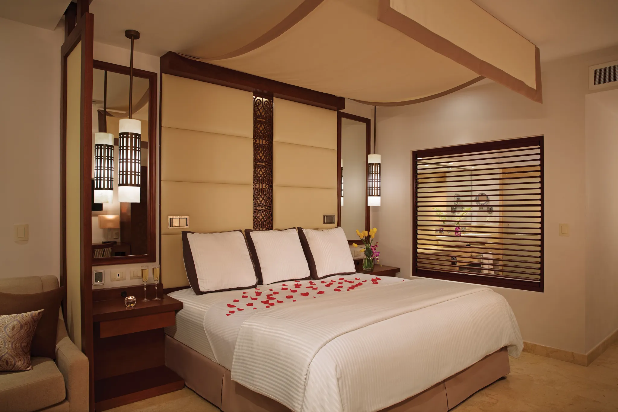 Preferred Club Junior Suite Ocean View king bed with romantic turndown service at Secrets Playa Mujeres Golf & Spa Resort.