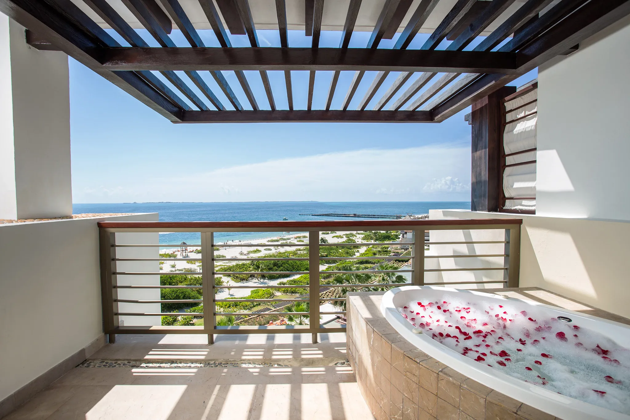 Preferred Club Master Suite Ocean Front balcony with private hot tub and ocean view at Secrets Playa Mujeres Golf & Spa Resort.