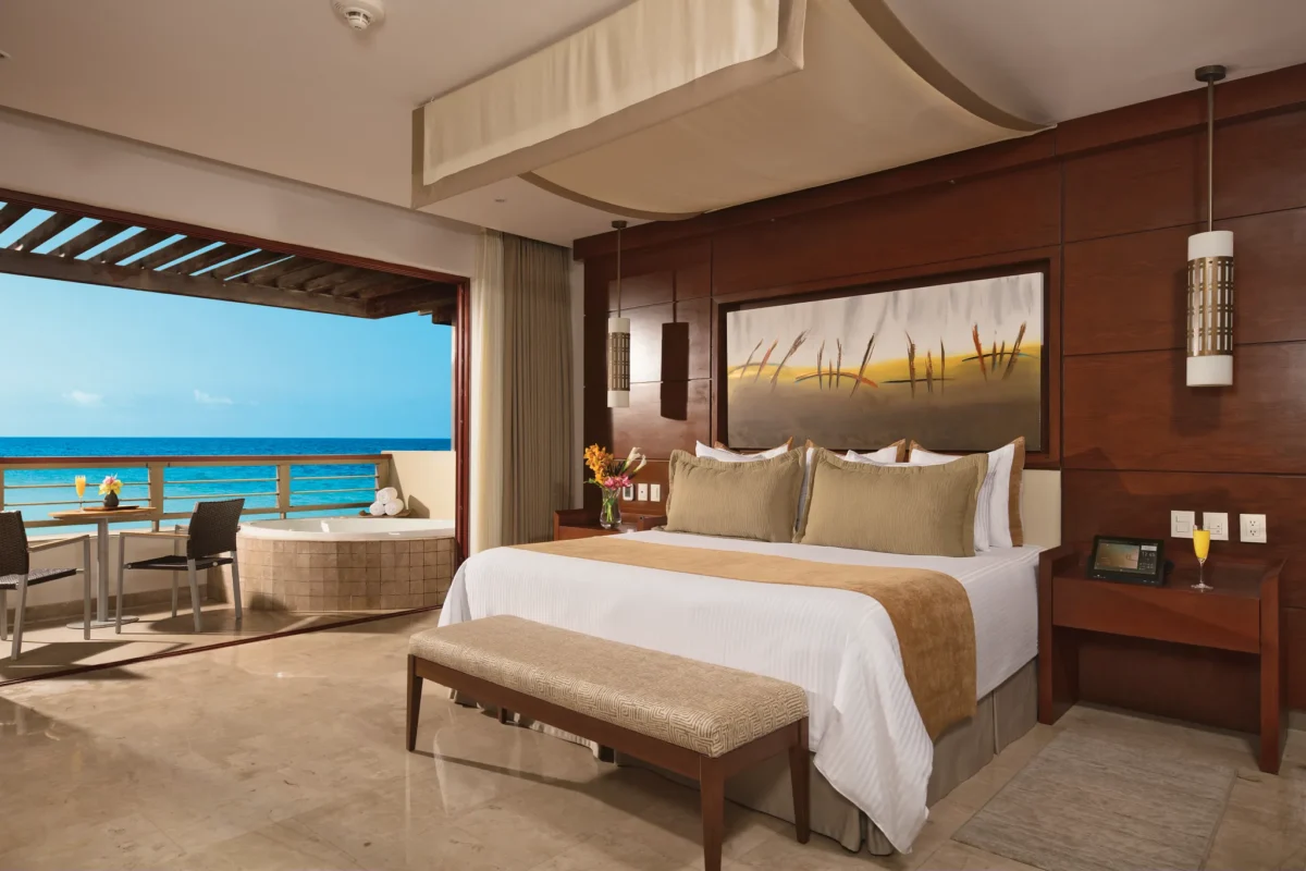 Preferred Club Master Suite Ocean Front king bedroom with ocean-view balcony at Secrets Playa Mujeres Golf & Spa Resort.