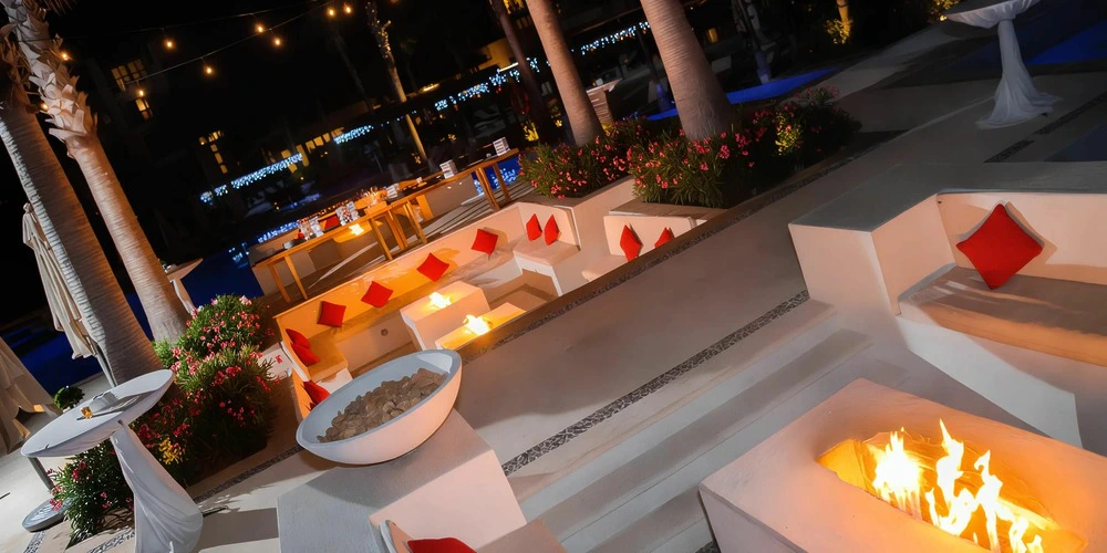 Sun Terrace fire pit lounge setup for evening wedding events at Secrets Playa Mujeres