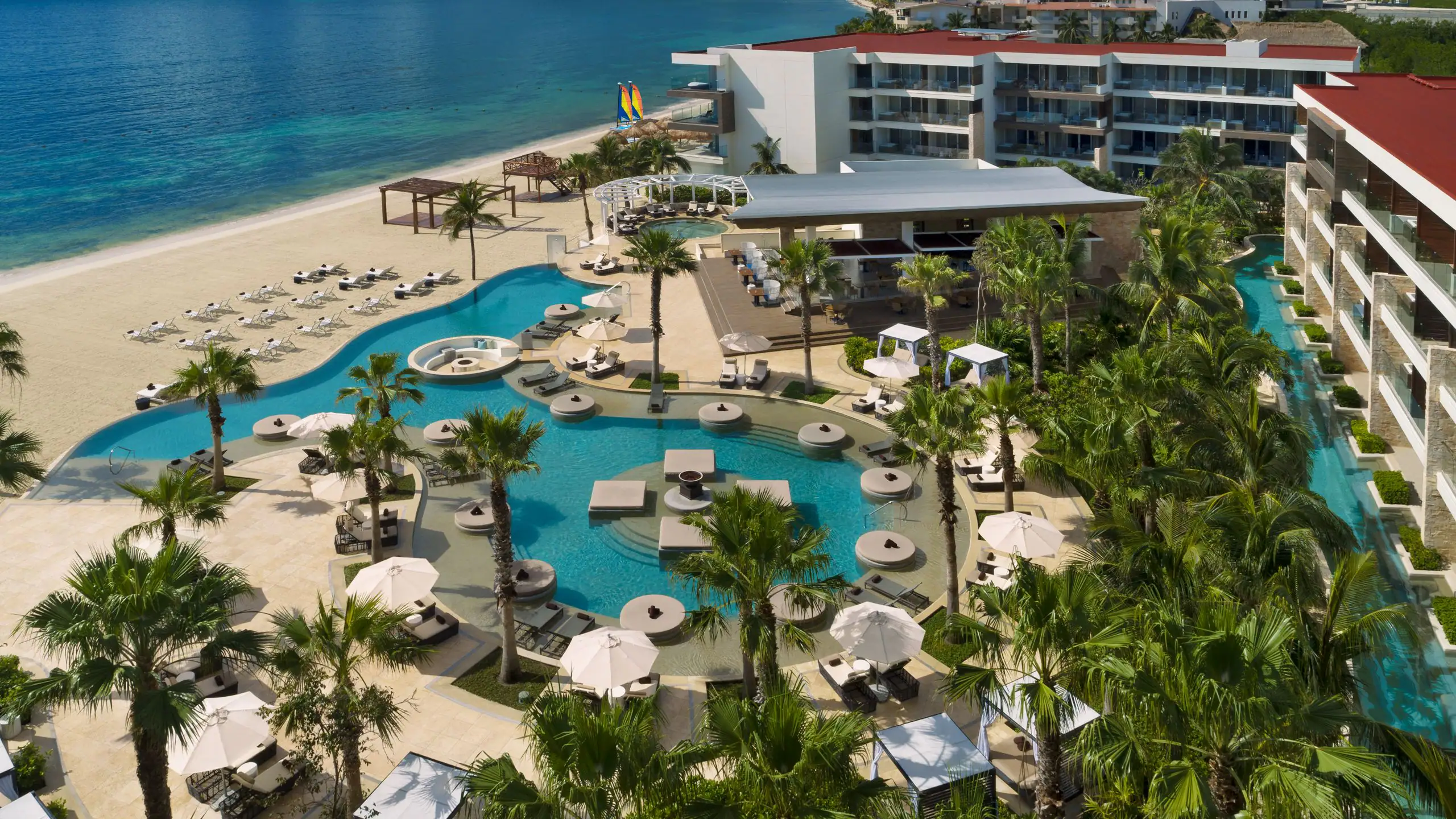 Secrets Riviera Cancun Resort & Spa adults-only all-inclusive with beachfront pools, lush tropical gardens, and romantic atmosphere in Puerto Morelos.